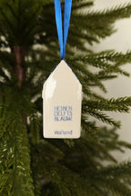 Back of the Delft blue canal house ornament showing the printed blue mark