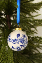 Closer view of the Delft blue floral bauble showing its painted blue flowers and leaves