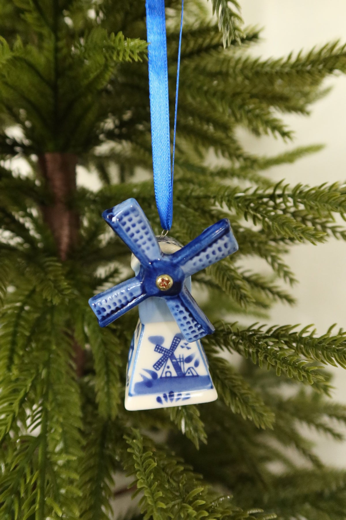 Closer view of the Delft blue windmill ornament showing its hand-painted windmill scene and gold sail pin
