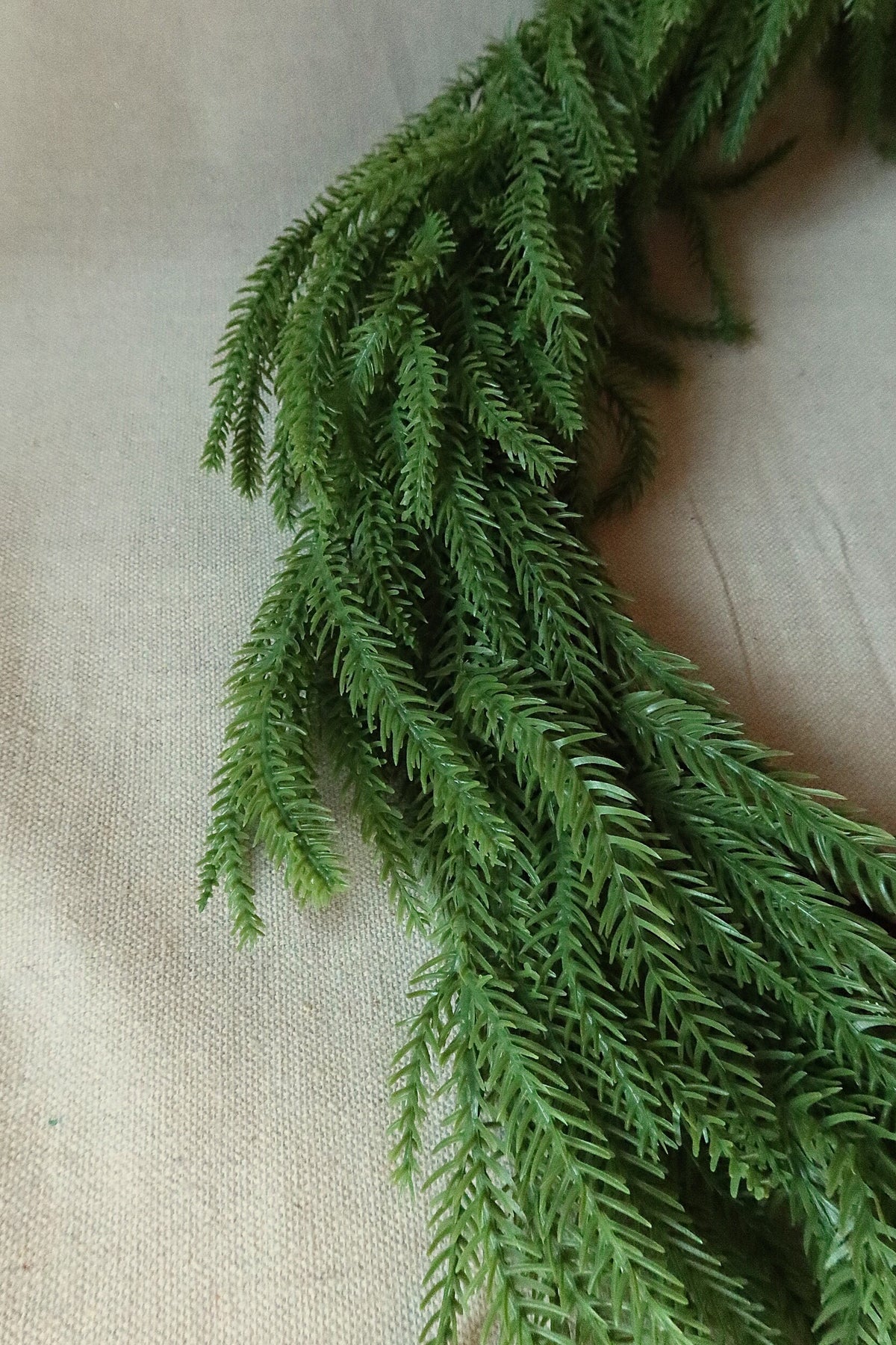Close-up of the long, drooping faux Norfolk pine branches on the 59 inch garland