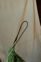 Close-up of the brown wrapped hanging loop at the end of the faux Norfolk pine garland