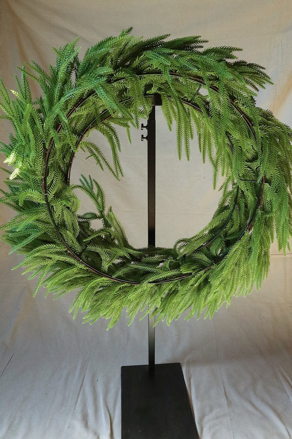 Back of the 36 inch faux Norfolk pine wreath showing its double-ring frame