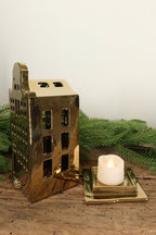 Bell-gable gold canal house tealight holder lifted off its base to show where the tealight sits