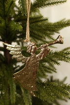 Closer view of the gold angel ornament showing its trumpet, feathered wings and hammered texture