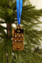 Closer view of the bell gable gold mini canal house ornament showing its curved gable and windows
