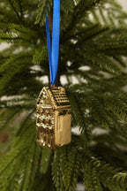 Side view of the pointed gable gold mini canal house ornament showing its tiled roof