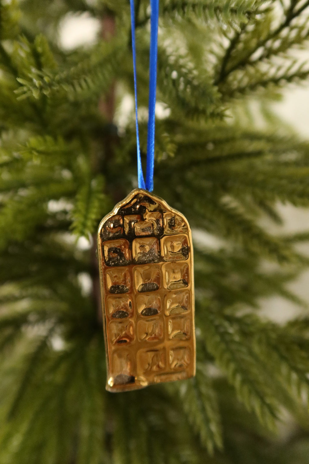 Closer view of the rounded gable gold mini canal house ornament showing its raised window grid