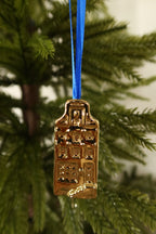 Closer view of the square gable gold mini canal house ornament showing its windows and doorway