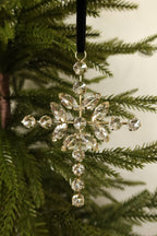 Closer view of the clear and gold jeweled cross ornament showing its sparkling rhinestone petals