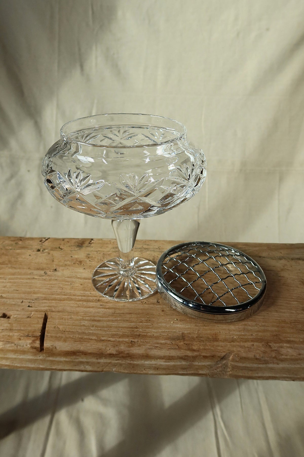 Cut crystal pedestal bowl shown with its silver-tone flower frog grille removed and set beside it