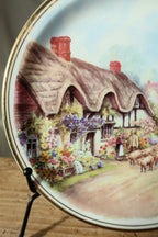 Close detail of the thatched cottage, flower garden, couple and sheep on the Royal Vale English cottage plate
