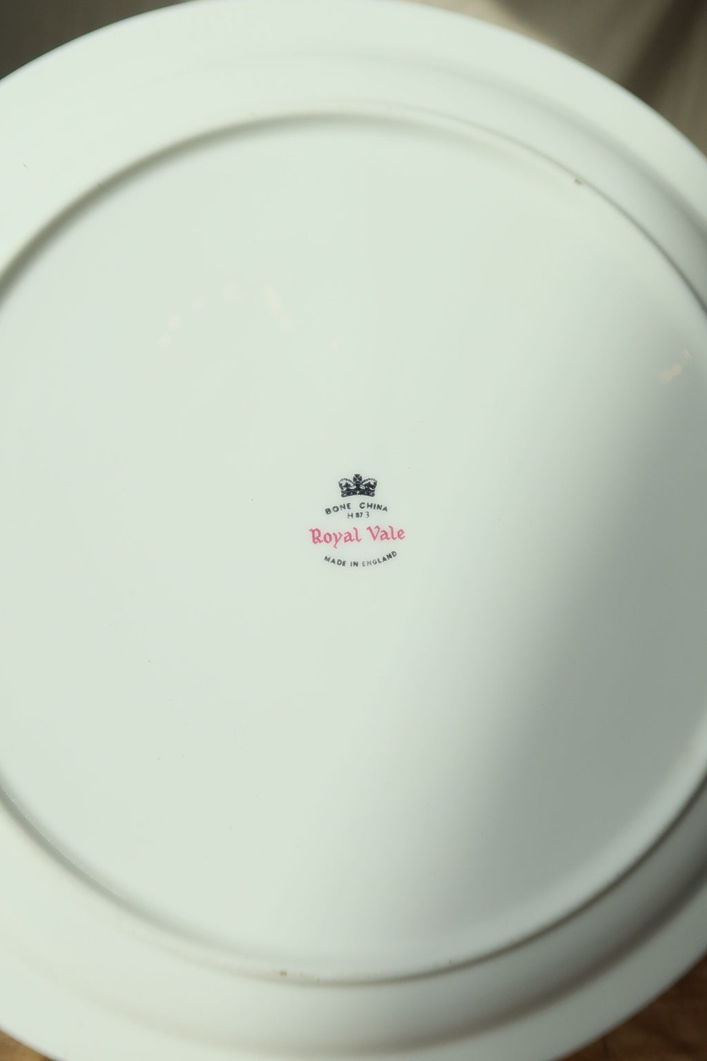 Back of the Royal Vale cottage plate showing the white bone china underside, foot ring and backstamp
