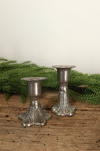 2.5 in silver cast iron taper candle holder shown beside the taller 3 in fluted-base holder for size comparison