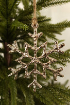 Closer view of the textured silver snowflake ornament showing its branched arms
