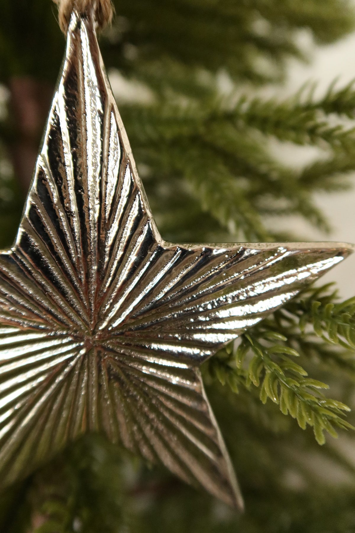 Close-up of the polished ridged silver finish on the metal star ornament