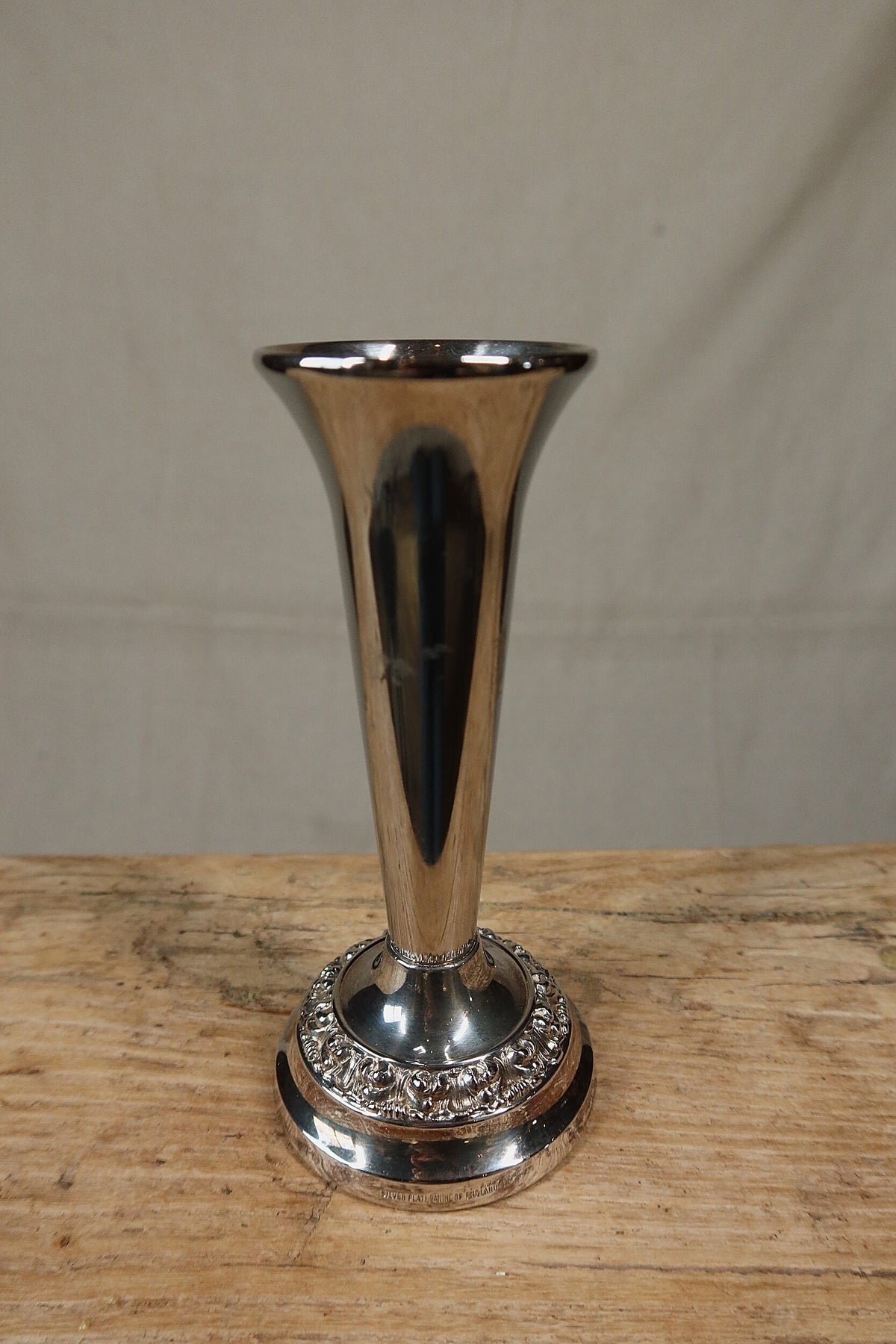 Closer front view of the Ianthe silver plate bud vase showing the flared trumpet neck and embossed floral border on the foot