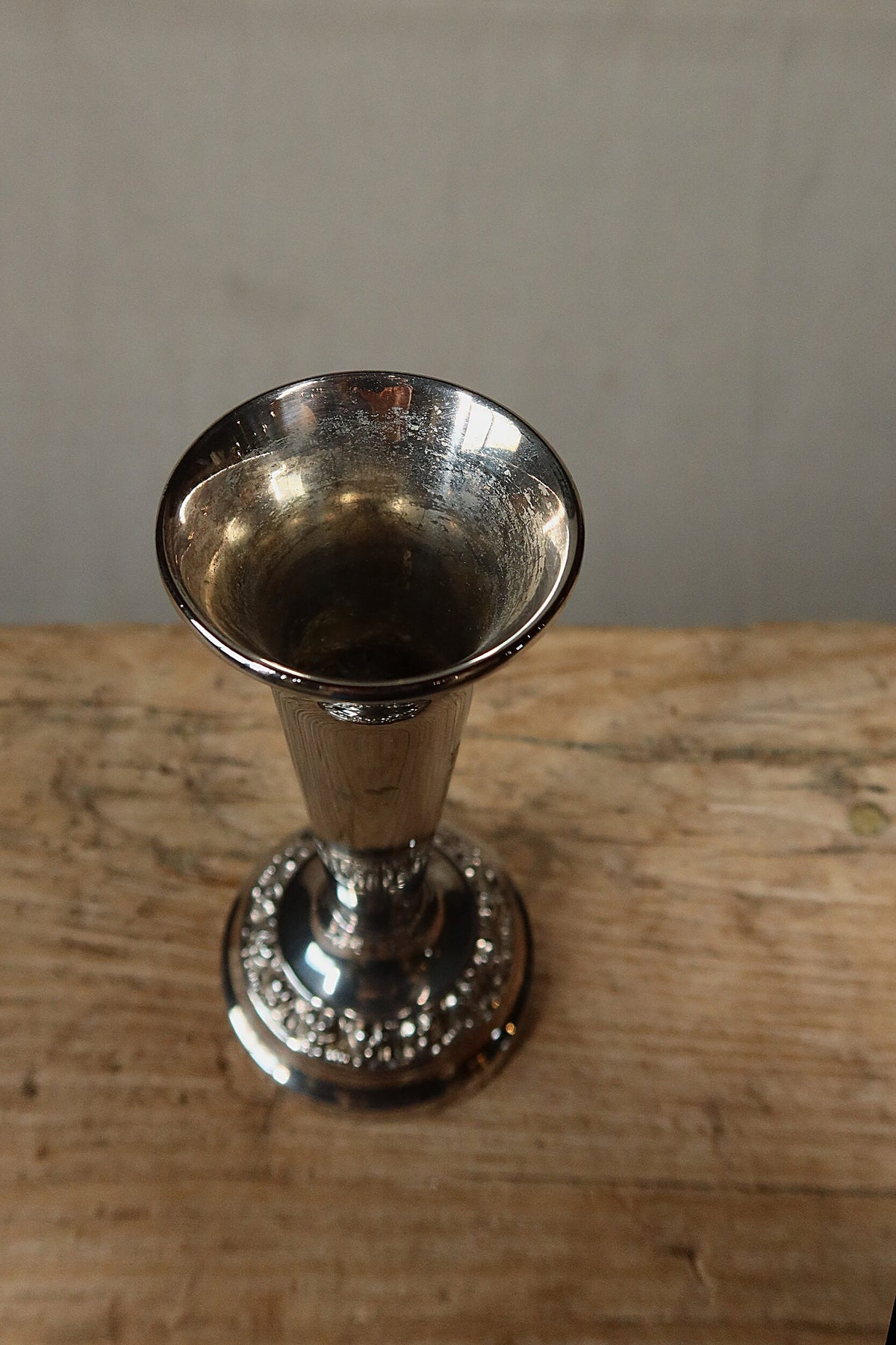 View into the mouth of the silver plate bud vase showing tarnish on the inside
