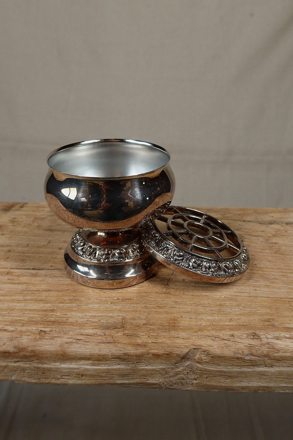 Silver plate rose bowl with its removable grille set beside it, showing the open bowl and footed base