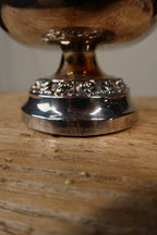 Close-up of the rose bowl's foot with the stamped Silver Plated Ianthe of England mark and warm tarnish to the silver
